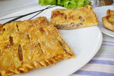 Puff pastry pie with minced meat in the oven