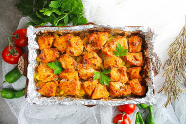 Chicken with potatoes in foil in the oven