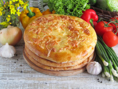 Yeast khachapuri in the oven with cheese