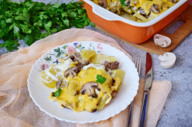 Potatoes with meat, mushrooms and cheese baked in the oven