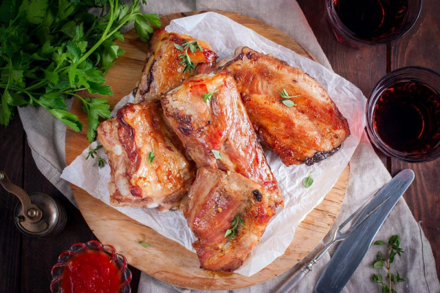 Pork ribs in marinade in the oven