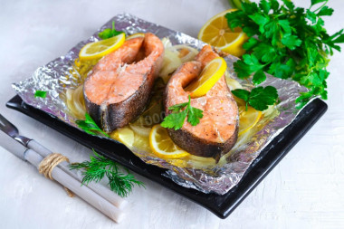 Red fish in foil baked in the oven with lemon