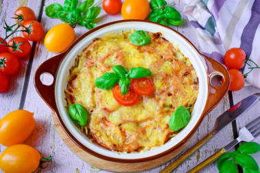 Pork meat under a potato coat with cheese in the oven