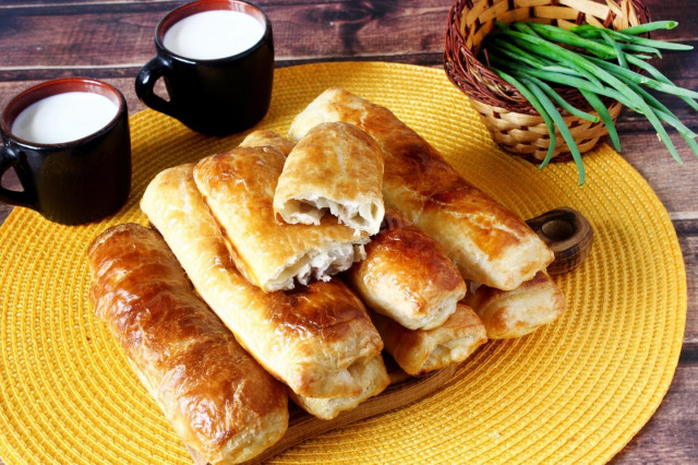 Puff pastry pies with meat in the oven