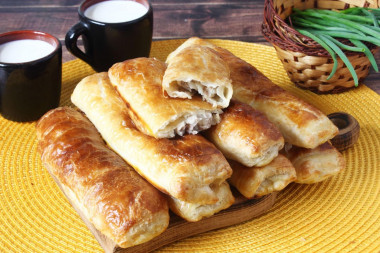 Puff pastry pies with meat in the oven