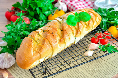 A loaf with cheese and garlic in the oven