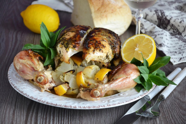 Whole chicken with lemon in the oven