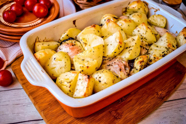 Chicken in mayonnaise with onions and potatoes in oven