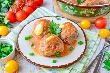 Meatballs with cheese in the oven in sour cream sauce