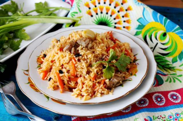 Uzbek classic pilaf with lamb in a cauldron