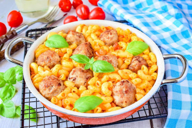 Pasta with meatballs in a frying pan