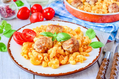 Pasta with meatballs in a frying pan