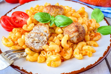 Pasta with meatballs in a frying pan