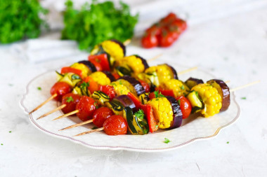 Shish kebab with vegetables in the oven on skewers