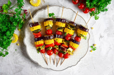 Shish kebab with vegetables in the oven on skewers