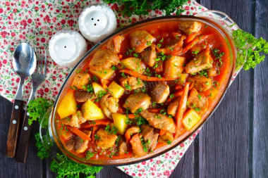 Potatoes with meat in a duck house stewed in the oven