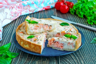 Pie with red fish in the oven