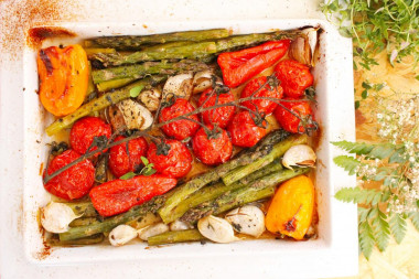 Fresh green asparagus in the oven with vegetables