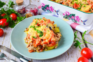 Potato casserole with minced meat and mushrooms in the oven