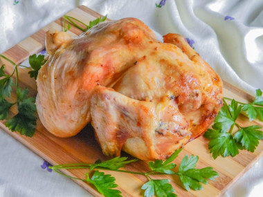 Whole chicken in the oven on a jar