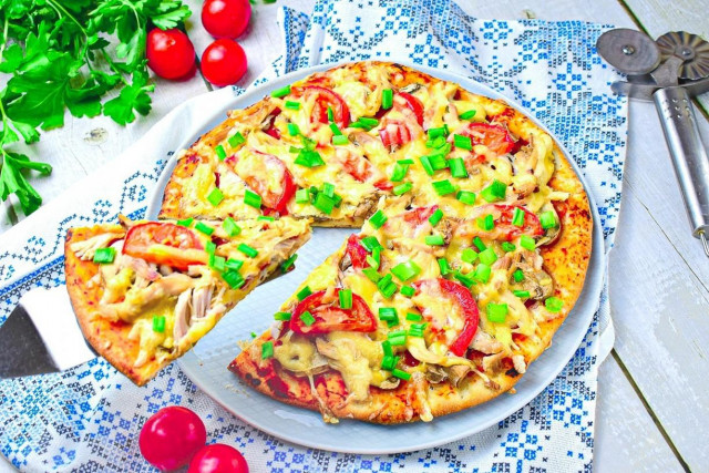 Pizza with chicken and mushrooms in oven