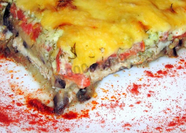 Eggplant with chicken fillet and tomatoes in the oven