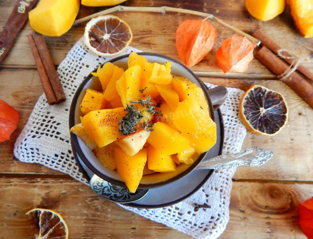 Pumpkin with apples and honey in the oven in pieces