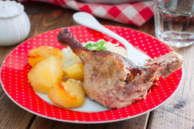 Duck in the oven in a sleeve with stuffed potatoes