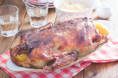 Duck in the oven in a sleeve with stuffed potatoes