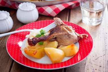 Duck in the oven in a sleeve with stuffed potatoes