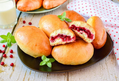 Lingonberry pies in the oven made of yeast dough