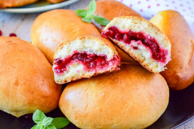 Lingonberry pies in the oven made of yeast dough