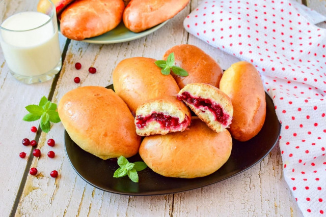 Lingonberry pies in the oven made of yeast dough