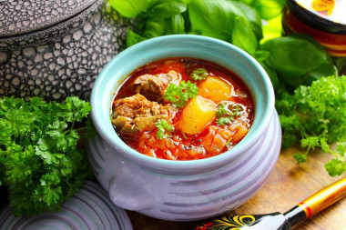 Cabbage soup from sauerkraut in the oven in a pot