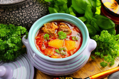 Cabbage soup from sauerkraut in the oven in a pot