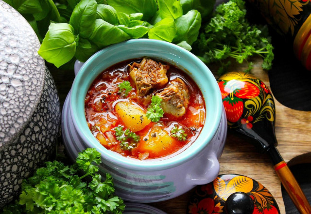 Cabbage soup from sauerkraut in the oven in a pot