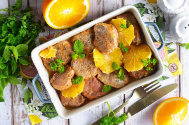 Pork meat with oranges in the oven