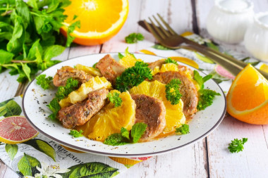 Pork meat with oranges in the oven