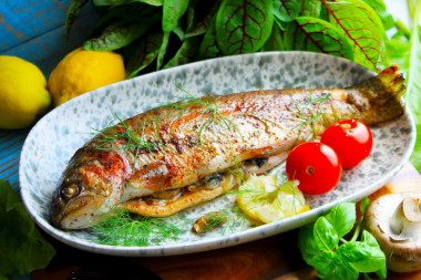 Rainbow trout in foil with mushrooms in the oven