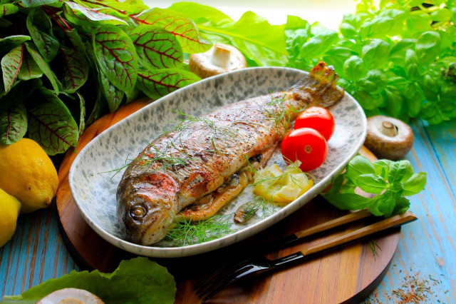 Rainbow trout in foil with mushrooms in the oven