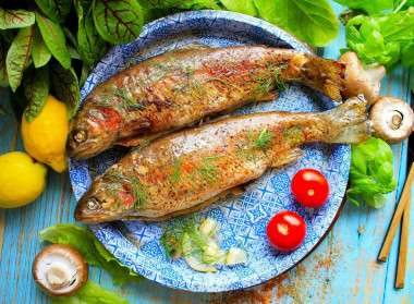 Rainbow trout in foil with mushrooms in the oven