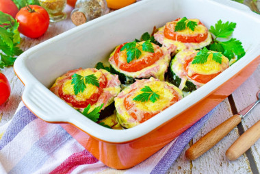 Zucchini with sausage and cheese with tomatoes in the oven