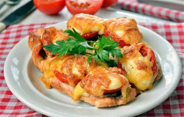 Chicken fillet baked in the oven with tomatoes and basil