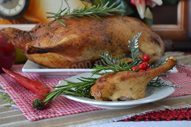 Duck baked in a sleeve in the oven with apples