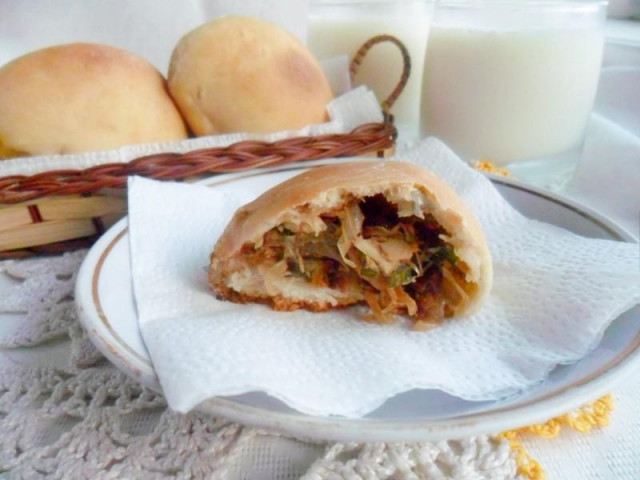 Yeast pies with cabbage and egg in the oven