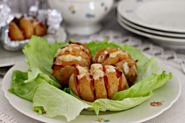 Potatoes with bacon in foil in the oven