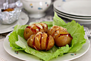 Potatoes with bacon in foil in the oven