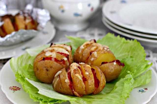 Potatoes with bacon in foil in the oven