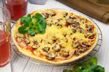 Pizza with ham mushrooms and cheese