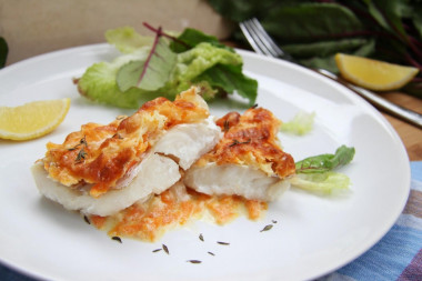 Hake in the oven with onions, carrots and sour cream